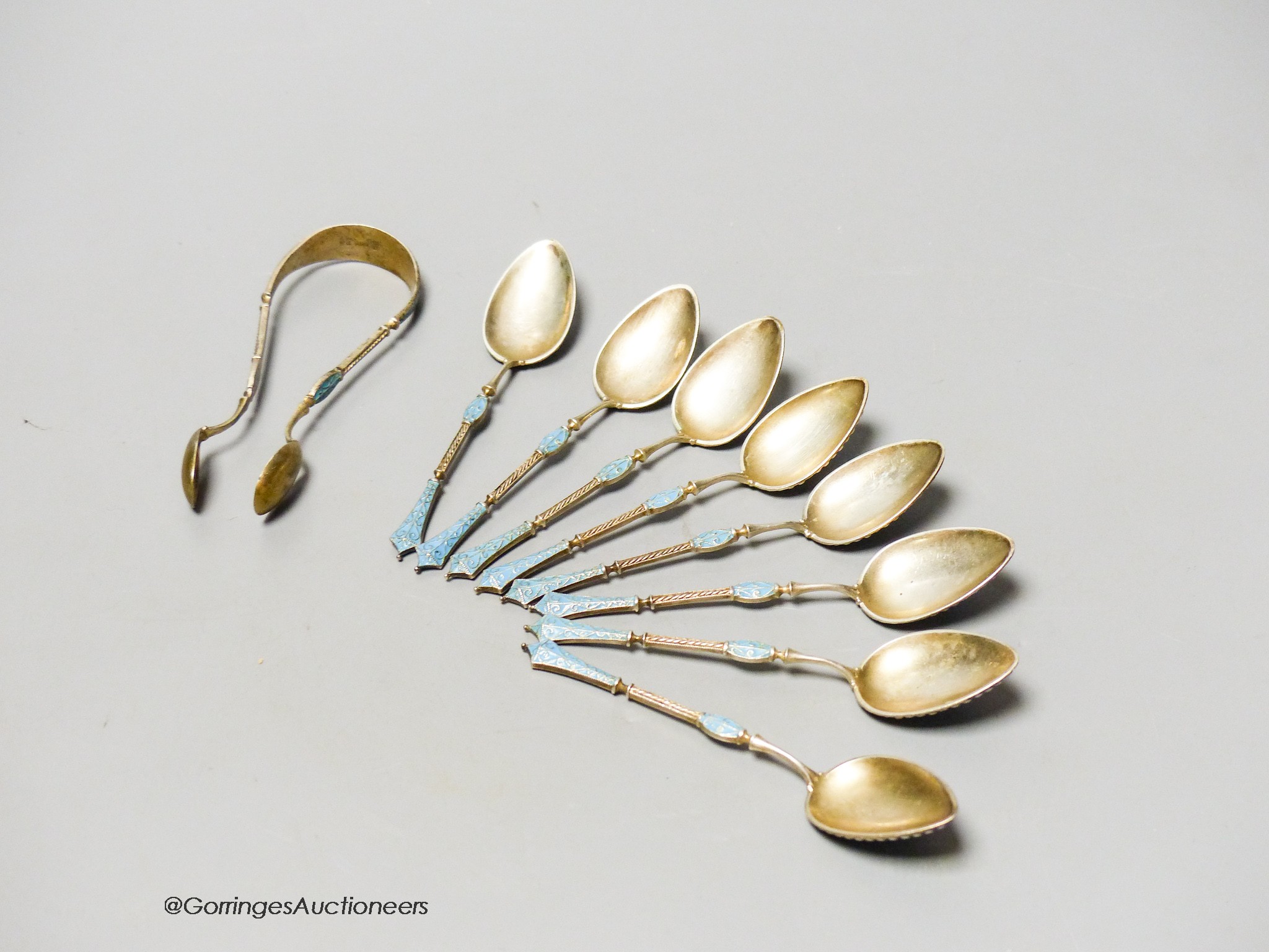 A set of eight Norwegian white metal and enamel coffee spoons and sugar tongs, by Marius Hammer, tongs only marked, gross 3 oz.